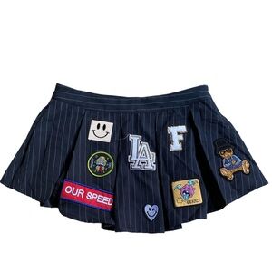 Black pinstripe mini skirt with patches and embroidery